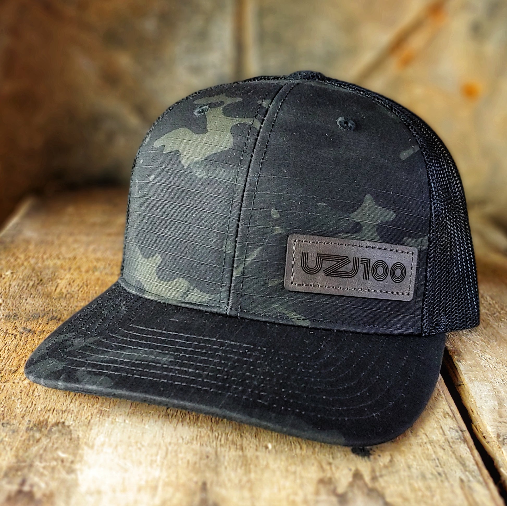 UZJ100 - Black multicam trucker hat - Merch-Mkt